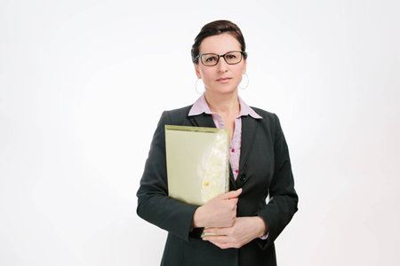 Beautiful businesslady in black jacket isolated on white backgroundの写真素材