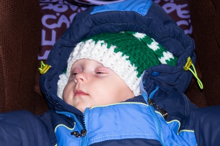 Portrait of 5 months old baby boy old sleeping on the stroller.の写真素材