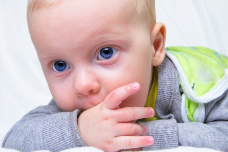 Portrait of serious 6-month old baby boy の写真素材