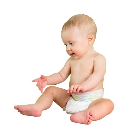 Eight month boy sitting on sofa, isolated on white background.の写真素材