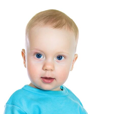 Portrait of 8-months old baby boy in blue t-shirt, on white background.の写真素材