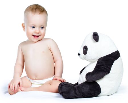 Nine month boy and toy sitting, on white background の写真素材