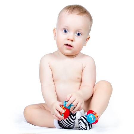 Nine month boy sitting, on white background の写真素材