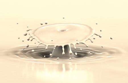 Coffee with milk splash and drops with reflection, close-up view の写真素材