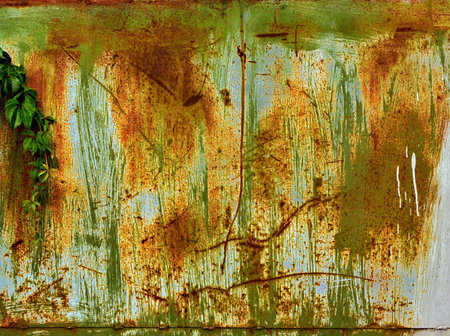 Old metal  surface covered with several peeling layers of paint