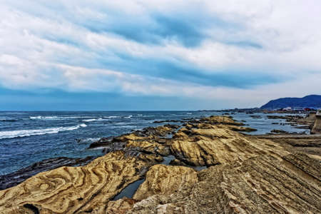 Japan Chiba coast. Rocks, sky and wavesの写真素材