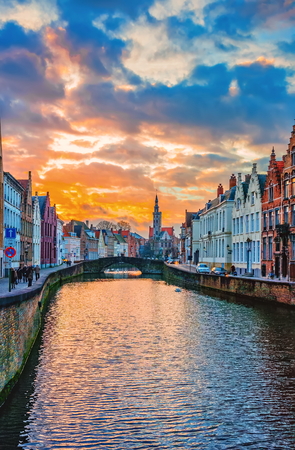BRUGGE, BELGIUM - JANUARY 03, 2013:  Sunset view along the Spiegelrei canal towards Jan Van Eyckplein and the late gothic Poortersloge (Burghers' Lodge), Bruges, Belgiumのeditorial素材