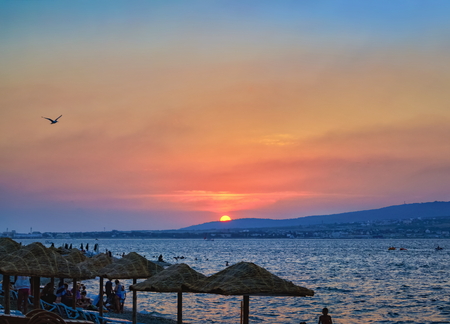 GELENDZHIK, KRASNODAR REGION, RUSSIA - AUGUST 11, 2012: Sunset overlooking sea bay and beach with parasols, Black sea coast, Gelendzhik, Russiaのeditorial素材