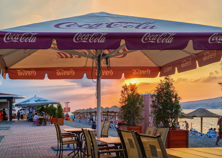 GELENDZHIK, KRASNODAR REGION, RUSSIA - AUGUST 11, 2012: Small caffee at seafront of Gelendzhik resort on sunset, Black sea coast, Gelendzhik, Russiaのeditorial素材