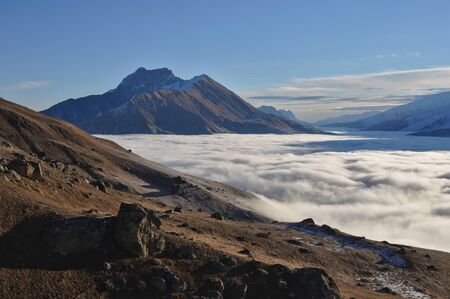 Mount Tbaukhokh and Gizeldon valley covered by clouds, a view from above the clouds. North Ossetia-Aiania, Russiaの写真素材