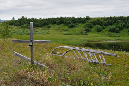 Traditional nenets grave with an orthodox cross, a deer's bell, and a sled for afterlife. Yamal Peninsula, Russiaの写真素材