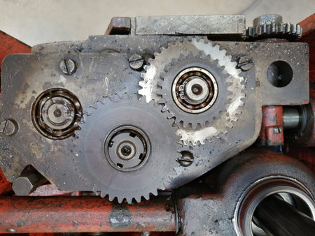 Metal gears assembled in a complex mechanism on professional equipment shot from above