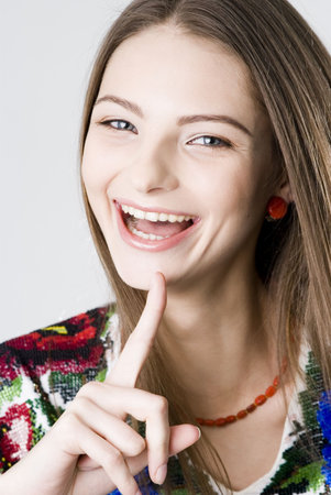 Young pretty laughing girl closeup studio portraitの写真素材