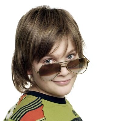 Handsome smiling young boy looking over sunglassesの写真素材