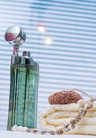 Bath background with perfume, towel and seashellsの写真素材