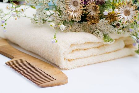 Bath background with towel, comb and flowersの写真素材