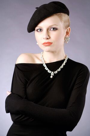 Beautiful young retro lady in black studio portraitの写真素材