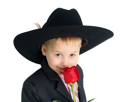 Little boy smelling a rose closeup portraitの写真素材