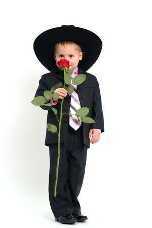 Little boy in hat posing with roseの写真素材