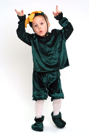 Little grimacing boy in costume studio shotの写真素材