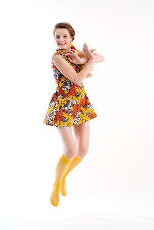 Funny jumping girl in dress and yellow stockingsの写真素材