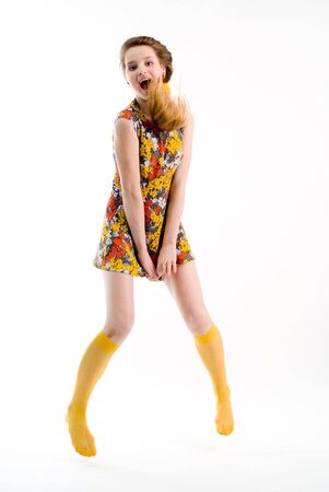 Expressive jumping girl in dress and yellow stockingsの写真素材