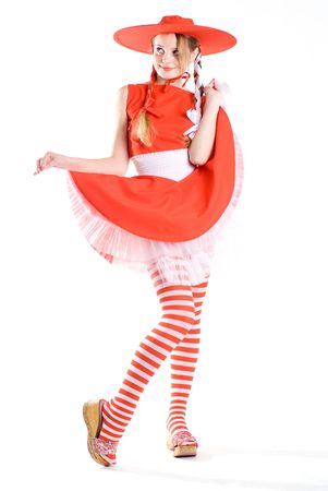 Pretty girl in red dress posing at white backgroundの写真素材