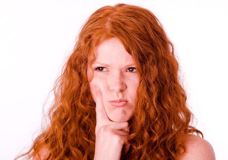 Angry pouting offended girl with red hair. White balance correctedの写真素材