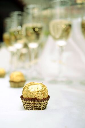 Chocolates and glasses of white wineの写真素材