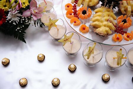Fruits, chocolate candies and alcohol decorated on the tableの写真素材