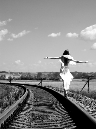 Pretty girl balancing on the railwayの写真素材