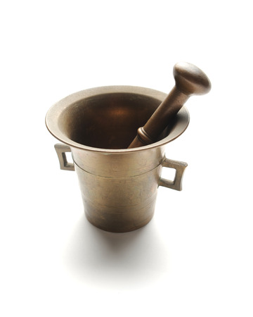 Antique copper mortar and pounder at white の写真素材