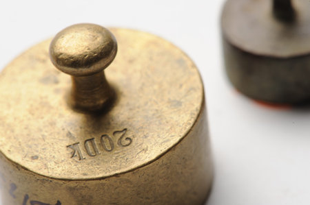 Old measure weights closeup at white 