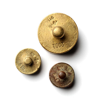 Three little antique measure weights top viewの写真素材