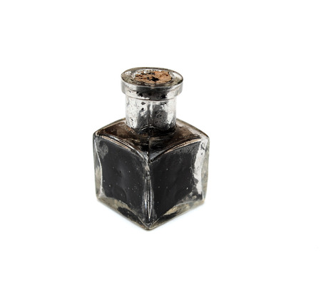 Retro inkpot poured with black inkの写真素材