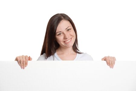 Girl behind a large blank white sheet of paperの写真素材