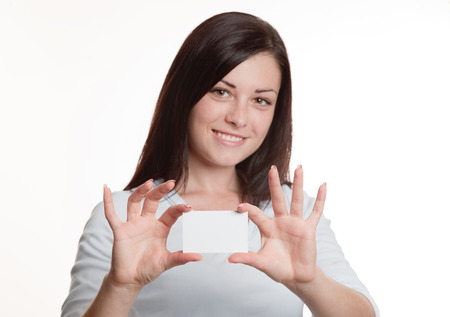 Pretty girl holding empty white business cardの写真素材
