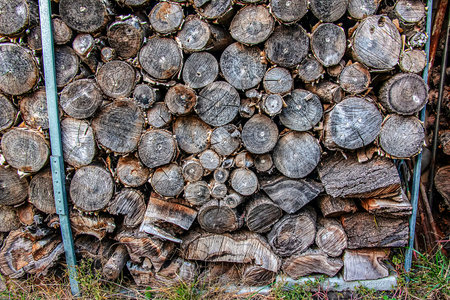 A pile of stacked firewood prepared for heating a house. Heating in winter. Isolation concept