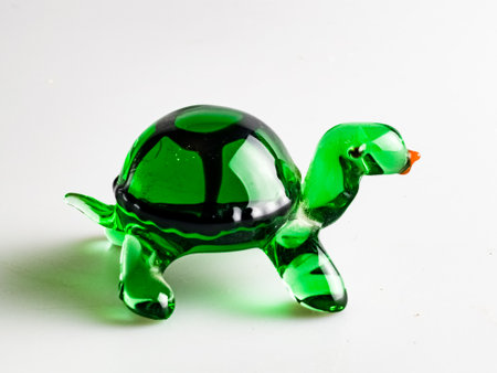 A figurine of a green turtle, specially made of glass on a white background.の写真素材