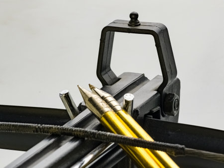 Black training crossbow with black string and arrows on a white background. Close-up. Selective focus. Sight view.の写真素材