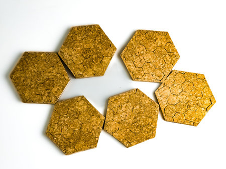 Six cork hot plate trivets in hexagon shape isolated on white background.