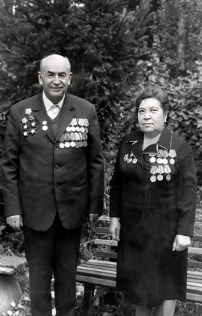 Vintage portrait of a family of World War II veterans. Man and woman with medals and orders. Retro...
