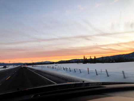 Sunset on road from Brundage Mountain ski resort. View from the car.の写真素材