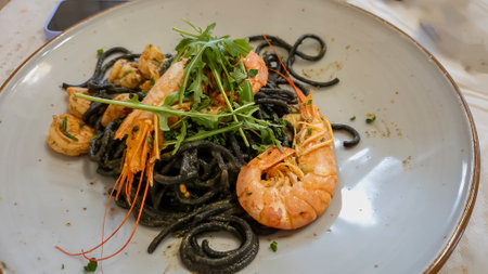 Plate of black spaghetti with prawn, mussels. Healthy food concept.の写真素材