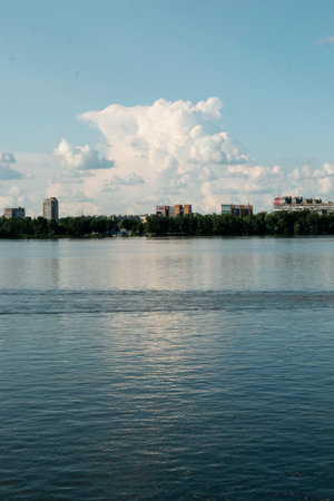 Panoramic view of left bank of the Dnieper River. Ukraine. The city of Dnieper. Reflection of sky with clouds on the water surface.の写真素材