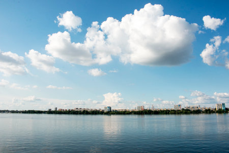 Panoramic view of the left bank of Dnieper River. Ukraine. The city of Dnieper. Reflection of the sky with clouds on the water surface.の写真素材