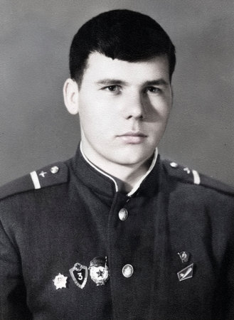 Vintage portrait of a young corporal of the Soviet army. Retro photo 1968