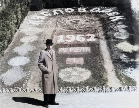 A vintage portrait of a man in a park against the backdrop of a flowerbed with the inscription Kislovodsk, April 1, 1962. Vintage black-and-white photo taken in the USSR.の写真素材