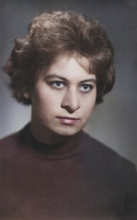 A vintage portrait of a young, attractive brunette with a beautiful 1960s-style hairstyle. Retro...