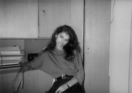 Nitra, Czechoslovakia - April 5, 1991: Vintage portrait of a young, pensive, beautiful woman. Retro photography.のeditorial素材